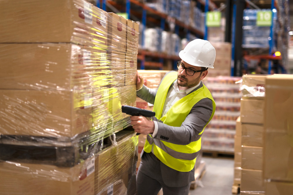 male warehouse worker using bar code scanner analyze newly arrived goods further placement storage department